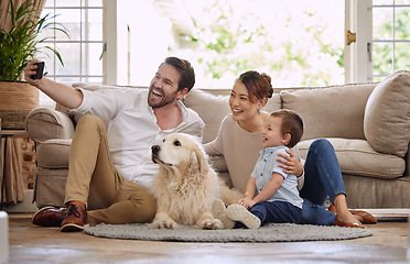 Image showing Selfie, social media and happy family in the living room with a dog for internet. Smile, playing and parents, baby and a pet taking a photo for the web, chat or profile picture on the house floor