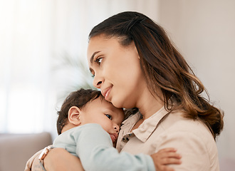 Image showing Family, love and mother carry baby for bonding, quality time and loving embrace together at home. New born, motherhood and calm mom holding infant for care, support and affection in living room