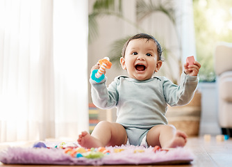 Image showing Portrait, smile and happy baby with toys on floor for fun, playing and game at home. Face, excited and toddler boy with creative building blocks for child development, learning or play in living room