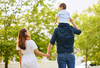 Image showing Dad, boy and girl in park with back, hug and sitting on shoulders with care, love and walk together in summer. Man, young children and embrace with piggyback, trees and forrest with bond on holiday