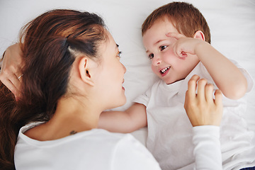 Image showing Bed, relax and above mother and baby, bonding and talking, wake up and embracing in their home. Top view, love and parent with child in a bedroom, happy and sweet while enjoying the morning together