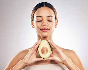 Image showing Skincare, beauty and woman with avocado in studio for organic, facial or treatment on grey background. Face, glow and girl model with fruit for eco, vegan or skin detox with anti aging antioxidants