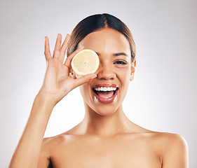 Image showing Woman, lemon and studio portrait for beauty, wellness and excited with facial glow by white background. Girl, model and healthy skincare with youth, makeup and cosmetics for self care with funny face