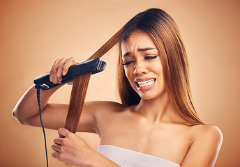 Image showing Woman with flat iron, haircare and heat damage, mistake and worried about hair loss on studio background. Electric straightener, female model with anxiety about keratin treatment fail and hairstyle