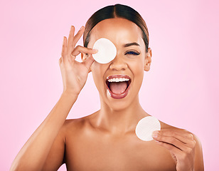 Image showing Happy woman, face and cotton pad in skincare, makeup removal or cosmetics against a pink studio background. Portrait of excited female person with cosmetic swab in beauty cleaning or facial treatment