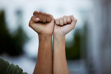 Image showing Fist, protest and power by people in solidarity for justice, human rights and democracy on blurred background. Hands, diversity and men united for activism, change and transformation or community