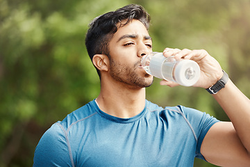 Image showing Fitness, man with in park, drinking water and hiking in nature for health and wellness during exercise. Drink, bottle and fit male on hike with trees for body workout, energy and training mindset.