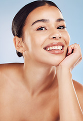 Image showing Portrait, cosmetics and woman with dermatology, beauty and pamper treatment against a blue studio background. Face, female person or model with grooming, skincare and luxury with makeup and self care