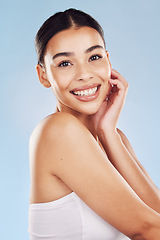 Image showing Portrait, skincare and woman with cosmetics, dermatology and grooming against blue studio background. Face, female person and girl with natural beauty, luxury and spa treatment with luxury and makeup