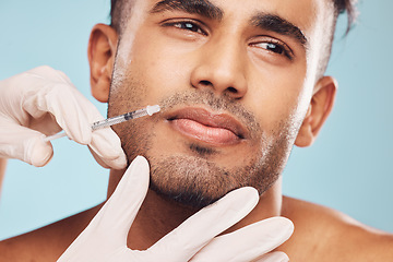 Image showing Beauty, botox and mouth with a man in studio on a gray background for a plastic surgery injection. Hands, skincare and syringe with a young male patient indoor for an antiaging facial filler closeup