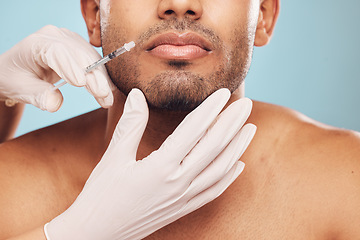 Image showing Skincare, botox and mouth with a man in studio on a gray background for a plastic surgery injection. Hands, beauty and syringe with a young male person indoor for an antiaging facial filler closeup