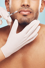 Image showing Skincare, botox and lips with a man in studio on a gray background for a plastic surgery injection. Hands, beauty and syringe with a young male patient indoor for an antiaging facial filler closeup