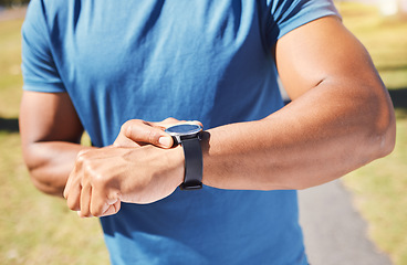 Image showing Fitness, stopwatch and man with a watch outdoor for training or running progress at park. Smartwatch on arm of athlete person in nature with time to exercise, start run and check performance goals