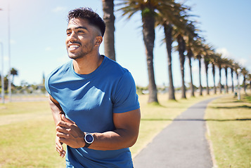 Image showing Fitness, smile and a man or runner outdoor for exercise, training or running at a park. Happy Indian male athlete in nature for a workout, run and cardio performance with a watch for progress or goal