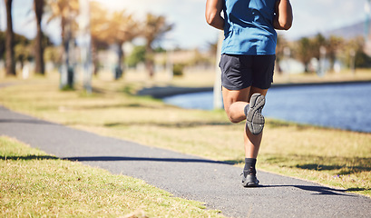 Image showing Fitness, legs and man or runner outdoor for exercise, training or running at a park. Closeup and feet of a male athlete in nature for a workout, run and cardio performance for health and wellness