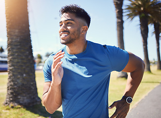 Image showing Fitness, running and man outdoor at park for exercise, training or cardio health. Happy Indian male athlete or runner in nature for a workout, run or jog while thinking of goals or performance