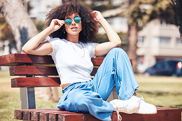 Image showing Fashion, bench and woman with sunglasses, portrait and summer with stylish clothes, trendy and gen z. Face, happy female person and girl outdoor, eyewear and casual outfit with beauty, edgy and relax