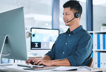 Image showing Call center, customer service and a man typing on computer with a headset for contact us communication. Crm, telemarketing and sales or technical support agent or consultant person at pc for advice