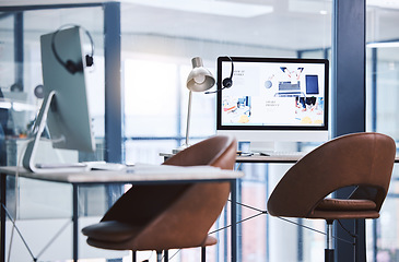 Image showing Internet, call center and headset on a computer screen in an empty office space for customer service. Crm, telemarketing and sales or technical support company with contact us website on a desktop