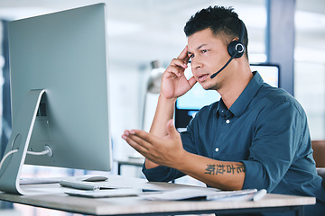 Image showing Mental health, businessman with stress and with headset at his computer in his workplace office at a desk. Telemarketing or call center, problem and problem with a male person at his workstation