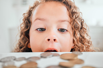 Image showing Finance, surprise and coins with child at home for savings, money and budget. Growth, learning and cash with face of shocked girl and change on table for investment, profit or banking responsibility