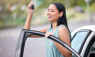 Image showing Excited, happy woman driver with new car, key and smile on face with loan, auto insurance and luxury transport. Happiness, freedom to drive and proud customer with keys for motor vehicle in street.