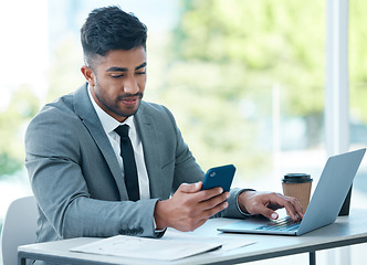 Image showing Man with laptop, phone and desk at startup checking email, social media and search on internet with business plan. Online report, networking and businessman in office typing or reading on cellphone.