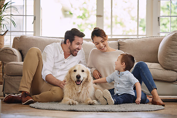 Image showing Family laugh, home and dog with child, mom and dad in living room with love in lounge. Animal, pet and mother with father and young kid with happiness in house with golden retriever and care on floor