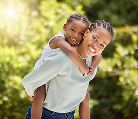 Image showing Piggyback, african mother and daughter in garden portrait with smile, game or happiness with love in summer sunshine. Black woman, mom and girl with hug, happy and outdoor together in park on holiday