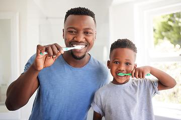 Image showing Portrait of a dad brushing his teeth with his child for dental care, health and wellness in the bathroom. Oral hygiene, teaching and young father doing morning mouth routine with his boy kid at home.