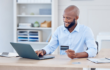 Image showing Black man, corporate credit card and laptop with ecommerce and fintech, payment with smile and bank app. Male professional at office with business purchase, online shopping and internet banking