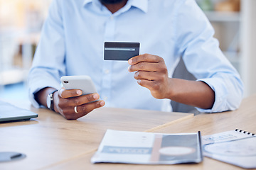 Image showing Black man, hands with credit card and smartphone for ecommerce and fintech, corporate payment and bank app. Male professional at office with business purchase, online shopping and internet banking