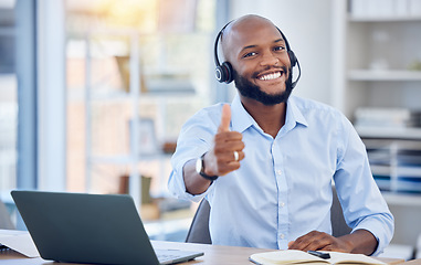 Image showing Man at callcenter, thumbs up in portrait and contact us, communication of support and agreement emoji. CRM, customer service and tech, male agent with headset and smile, success and yes hand gesture