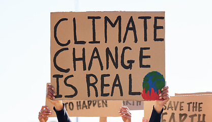 Image showing Protest, climate change and sign with a group of people outdoor at a rally or march for conservation. Global warming, freedom and environmental with a crowd walking together during a community strike