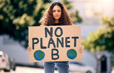 Image showing Woman, poster and portrait in street for planet, climate change and sustainable future in city. Girl, cardboard sign and activism for change, sustainability and justice for environment in metro road