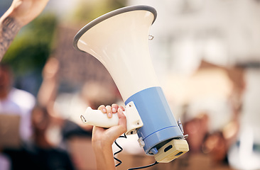 Image showing Hand, megaphone closeup and outdoor protest for change, justice or environment for people together in city. Bullhorn, loudspeaker and zoom for communication, speech or leadership for politics on road