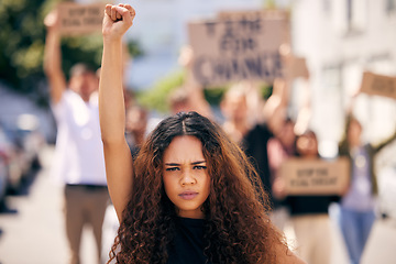 Image showing Woman, fist and portrait with protest crowd in street for planet, climate change or sustainable future. Girl, leadership and rally for earth, sustainability or justice for environment in metro road