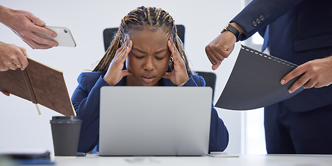 Image showing Headache, business and overwhelmed black woman surrounded in busy office with stress, paperwork and laptop. Frustrated, overworked and tired employee with anxiety from deadline time pressure crisis.