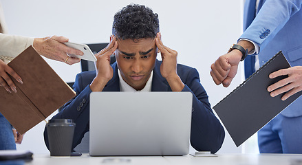 Image showing Headache, burnout and overwhelmed businessman surrounded in busy office with stress, paperwork and laptop. Frustrated, overworked and tired employee with anxiety from deadline time pressure crisis.