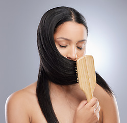 Image showing Woman, brush and hair for salon, grooming or healthy style against a grey studio background. Calm female person or model in beauty or brushing for straight haircare and clean hygiene or treatment