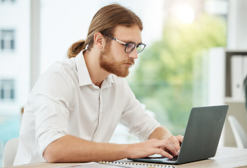 Image showing Typing, laptop and business man in office for copywriting, company newsletter and research article or blog. Focus, working and social media writer, editor or person at startup, online and computer