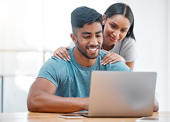 Image showing Couple, laptop and Indian man in a home with online shopping and ecommerce app with wife support. Mockup, young people and happiness from promotion email in a house at desk with woman supporting