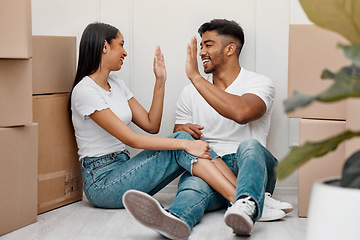 Image showing Box, celebration and couple high five in new home excited for property, apartment and real estate investment, Relationship, house and man and woman celebrate with smile, boxes and happy on moving day