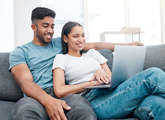 Image showing Couple, laptop and watching a video on a lounge sofa with happiness and love at home. Computer, streaming series and young people together on a living room couch in a house with tech and a smile