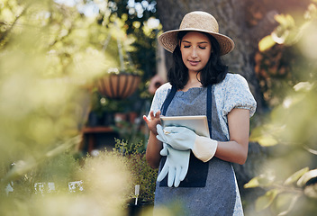 Image showing Florist woman, tablet and nursery for growth, data and typing on app in sunshine at sustainable small business. Girl, entrepreneur and inspection for plants, leaves and nature with analysis in spring