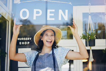 Image showing Portrait, nursery and open with a woman hanging a sign in the window of her shop for gardening. Small business, garden center and an excited young female entrepreneur opening her new flower store