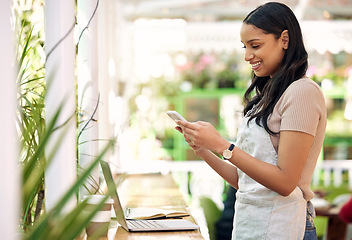 Image showing Happy, planning and a woman with a phone at a nursery for orders, business app or stock email. Smile, contact and a young florist with a mobile for social media, work management and connection