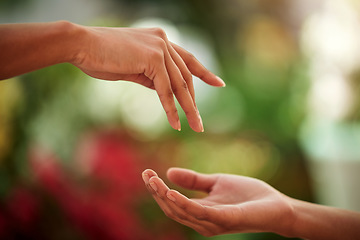 Image showing Hands, love and people with a reaching gesture in an outdoor green garden or park in nature. Connection, romantic and closeup zoom of a couple for support, romance or touch together outside.