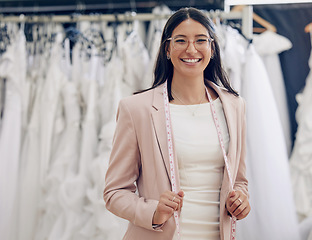 Image showing Happy, portrait of woman seamstress working and in a bridal boutique with measuring tape. Retail store, fashion and cheerful or excited female person at work with measurements at dress shop.