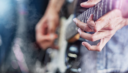 Image showing Guitar, stage and man hands at music festival show playing rock with electric instrument with lights. Sound, musician and party with live talent and audio for punk event with people at a concert